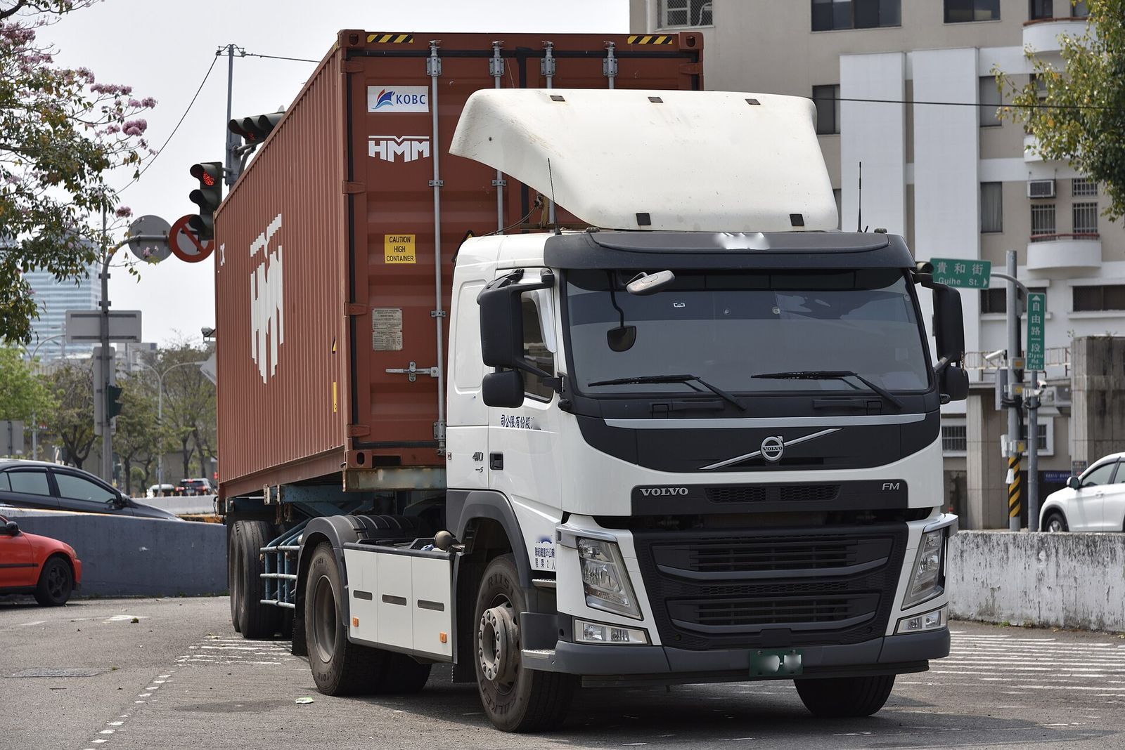 Truck hauling a shipping container on the road