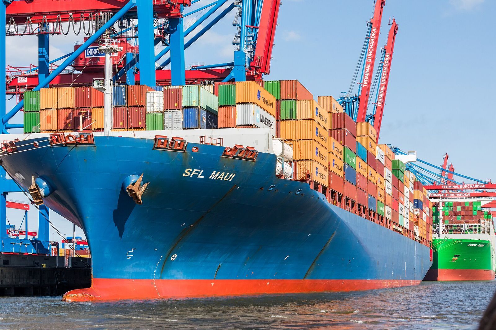 Container ship alongside port cranes